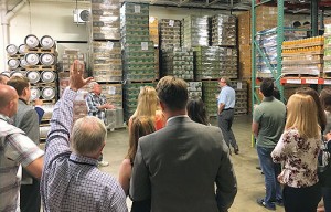 Ron Evans, a NexGen Ambassador, asking the guide – probably if he could help slightly reduce their beer inventory by taking a few pallets off their hands!